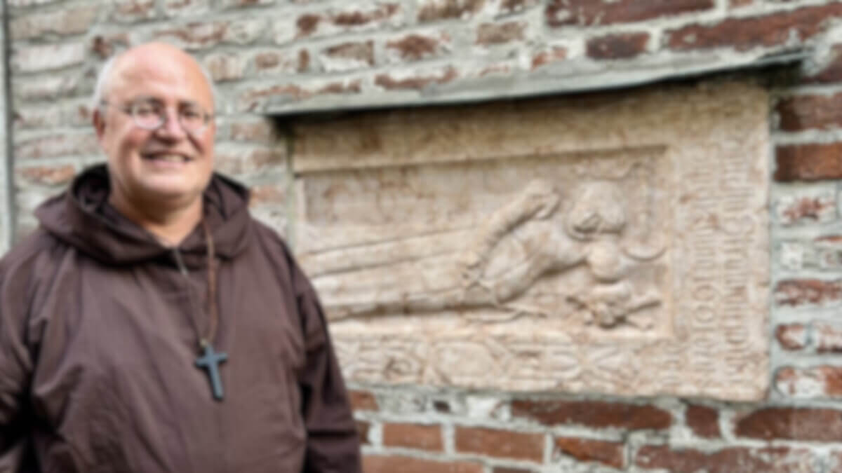 Ein Mönch steht vor der Frauenkirche in München